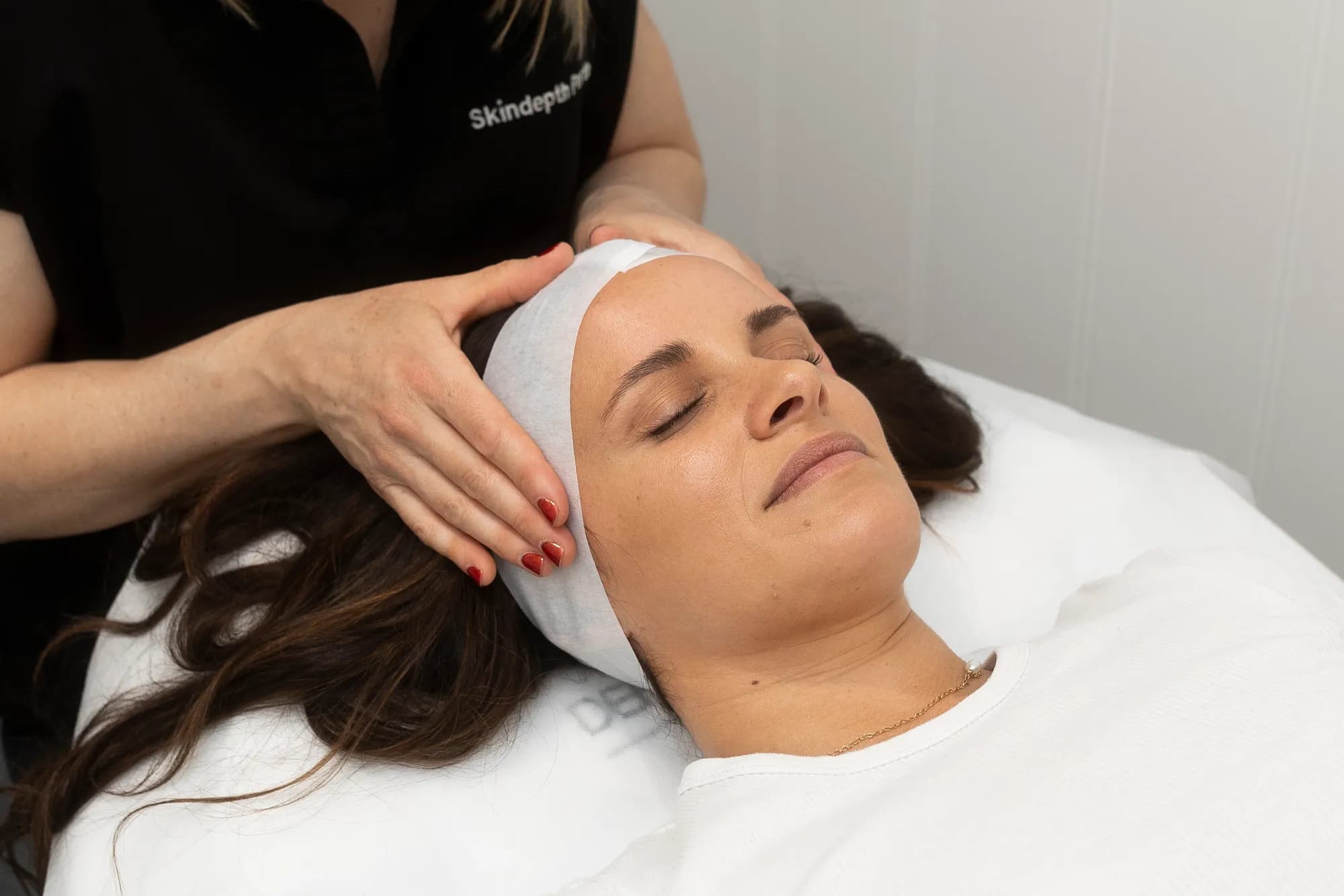 A clinician settling a reclining patient at the start of an appointment